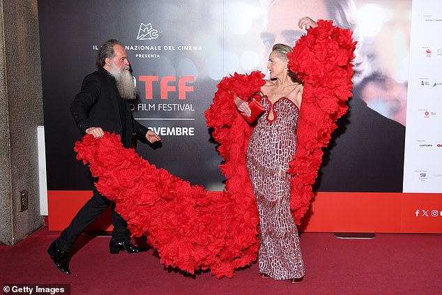 At one point, fashion designer Paris Libby was seen holding up the end of it's long train as the glamorous star posed for photos