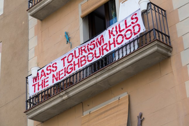 A protest banner against mass tourism in the Ciutat Vella (Old City), Barcelona.