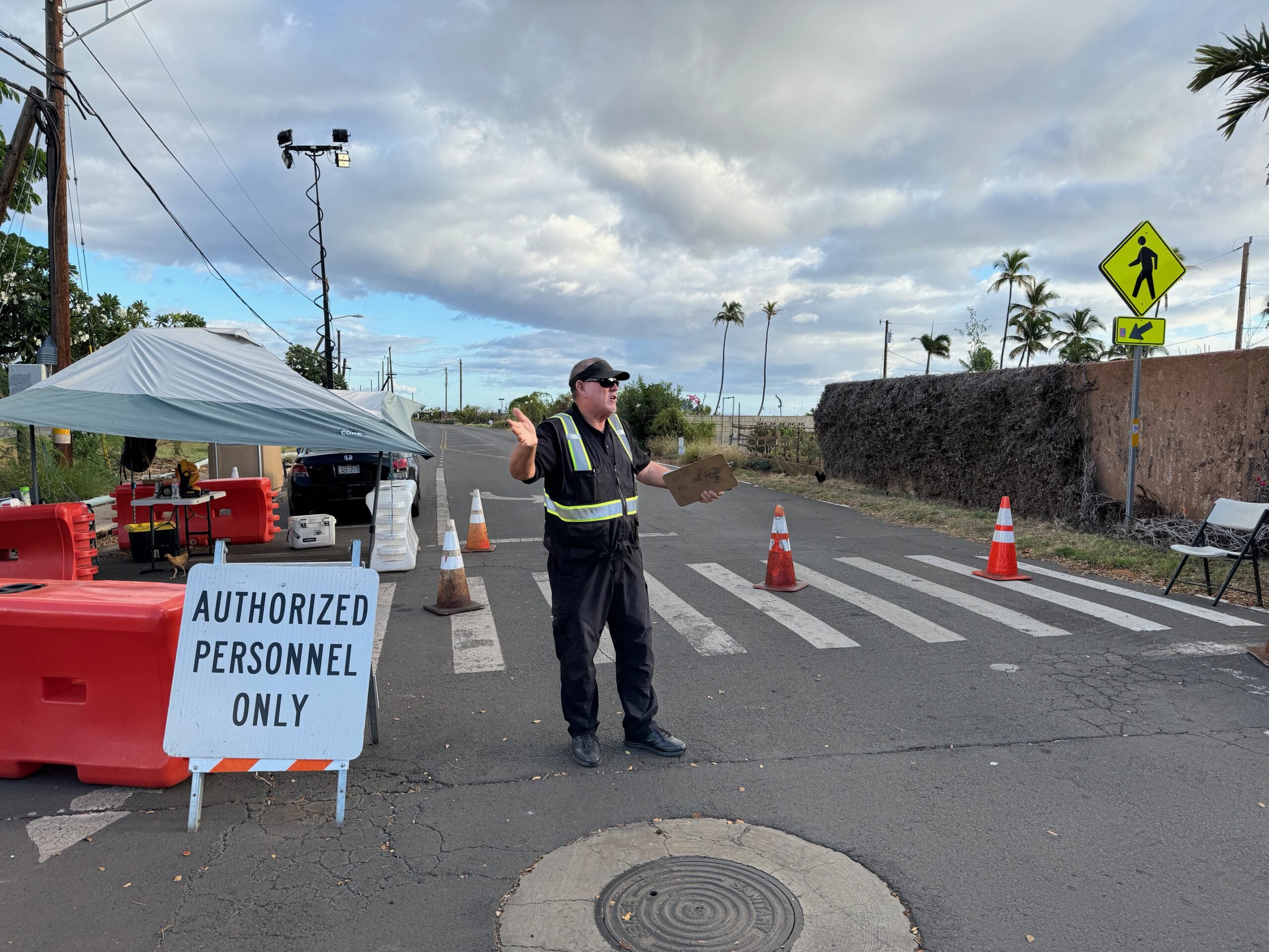 Tim Putnam, a guard for Aegaeon Securight, mans his post in Lahaina on Wednesday. HJI / ROB COLLIAS photo