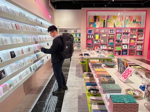 Man looking at greeting card inside store