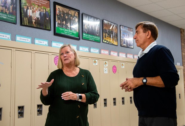 Thomas Jefferson Middle School Science Olympiad coaches Carol Haller, left, and Rich Bender reflect on more than 30 years of state and national competitions surrounded by team photos at the Valparaiso school on Wednesday, Nov. 6, 2024. (Michael Gard/for the Post-Tribune)