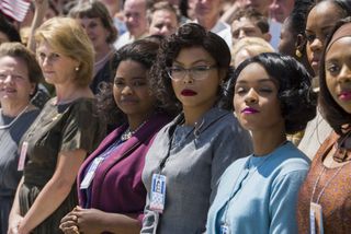 taraji p henson octavia spencer and janelle monae stand in a line with a group of women in 60s clothing in hidden figures