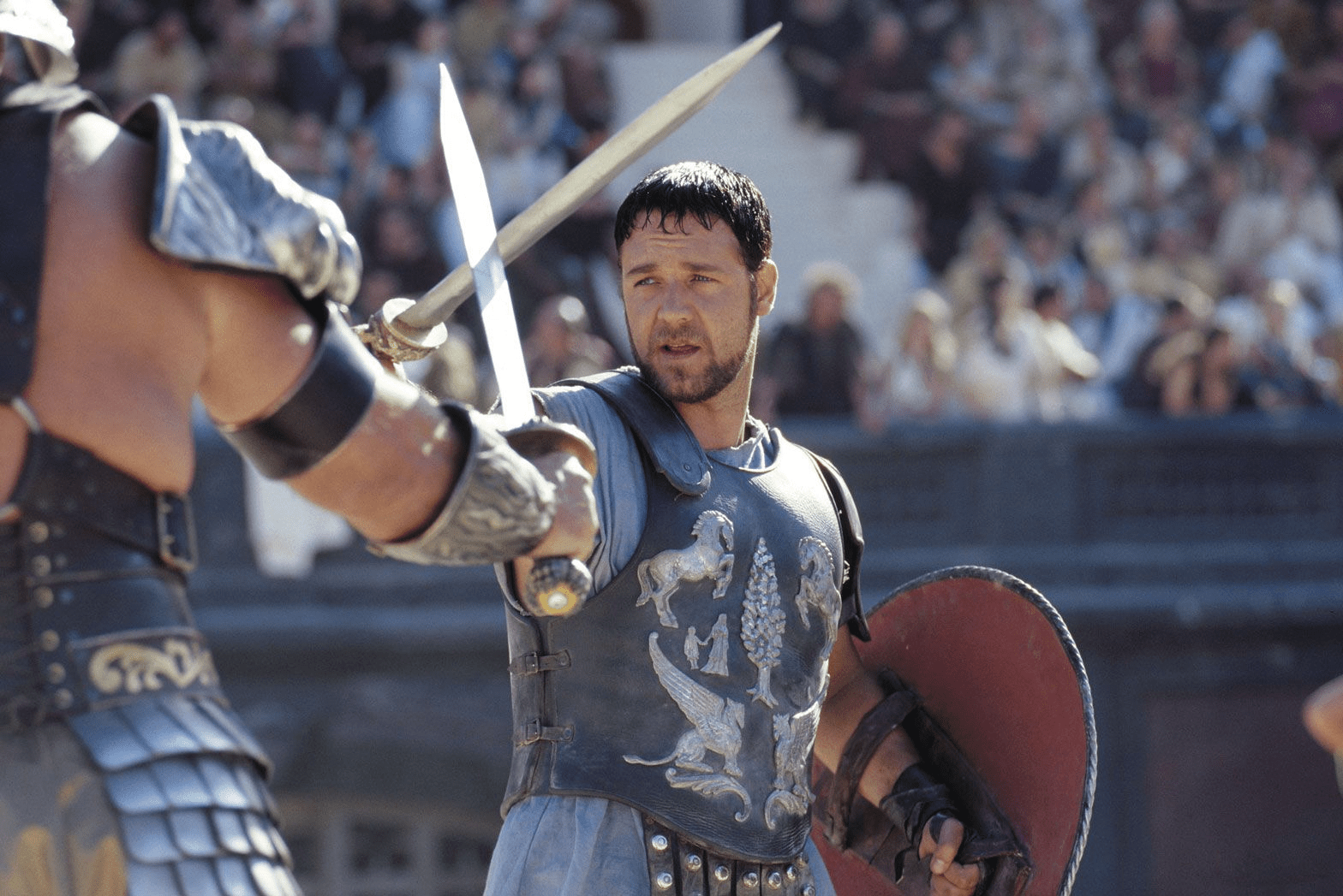 Russell Crowe crossing swords with another gladiator in Gladiator.