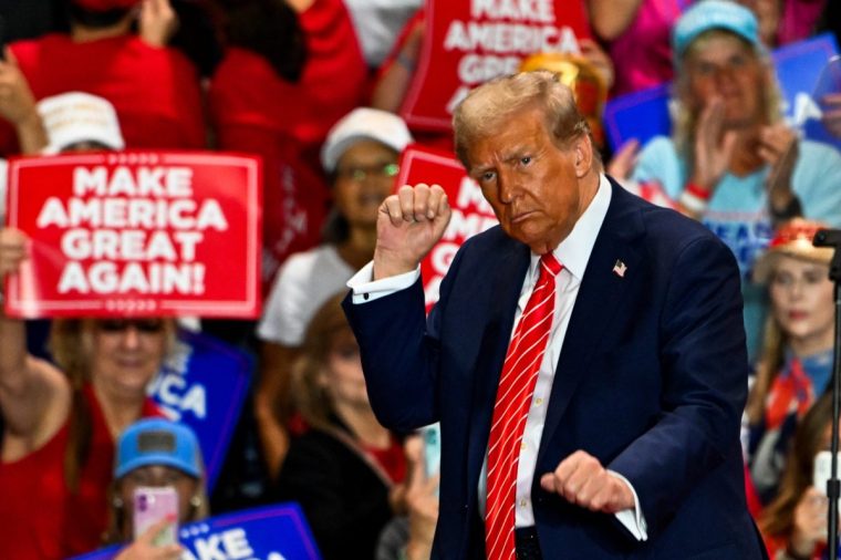 Former US President and Republican presidential candidate Donald Trump dances as he leaves a campaign rally in Rocky Mount, North Carolina, on October 30, 2024. (Photo by CHANDAN KHANNA / AFP) (Photo by CHANDAN KHANNA/AFP via Getty Images)