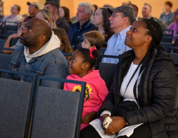 Sage Tatem, 6, listens with her parents Gracie and Tremayne Tatem of Allentown as Lehigh Valley entrepreneur, pilot and astronaut Jared Isaacman, not shown, talks about the Polaris Dawn mission and answers questions Sunday, Nov. 17, 2024, at the Da Vinci Science Center in Allentown. The Sept. trip to space included the first private spacewalk, by Isaacman, among other historic milestones. (April Gamiz/The Morning Call)