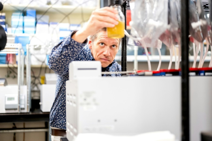 Associate Professor Matthias Hess demonstrates a bioreactor used to study reducing methane emitted by cow burps at UC Davis in California