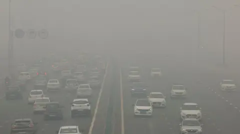 Reuters Traffic passes on a road as the sky is enveloped with smog after Delhi's air quality turned 