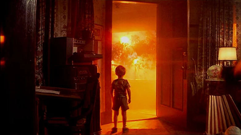 A child looking at a mysterious light through a doorway in Close Encounters of a Third Kind