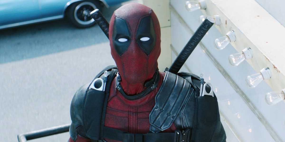 Deadpool with the iconic red and black mask, armed with swords on their back, posing confidently.