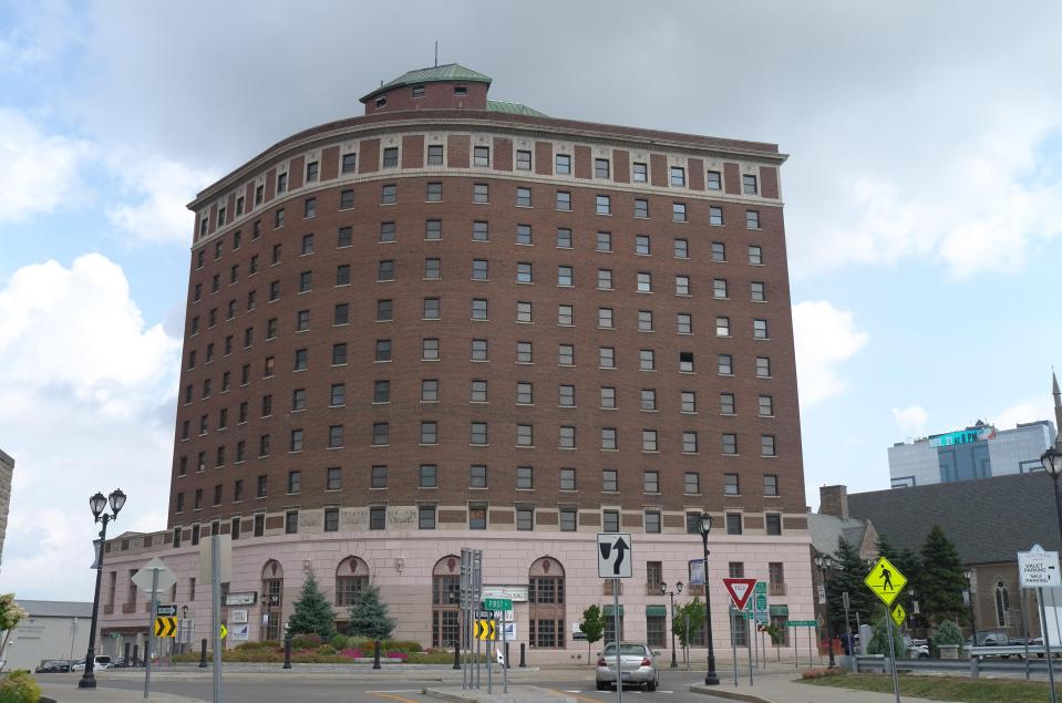 The abandoned hotel stands bizarrely alone on the corner of a street