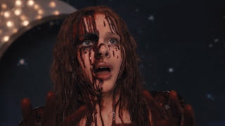 Chloe Grace Moretz looking terrified covered in blood as Carrie.