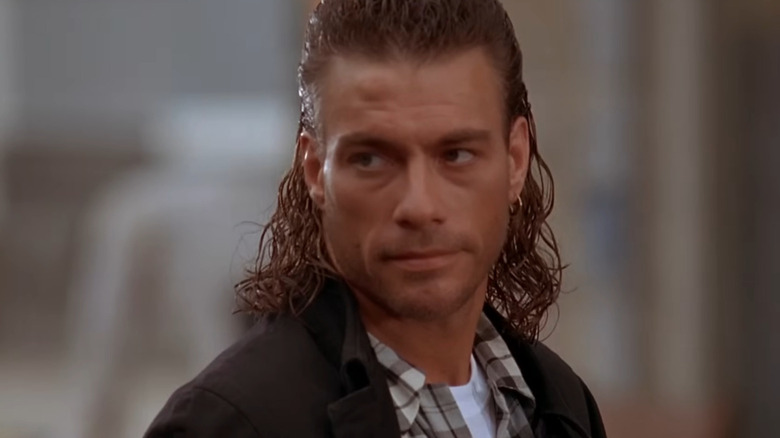 Chance Boudreaux with a mullet looking at someone off camera in Hard Target