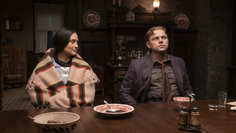 Mollie and Ernest sitting at a dining room table in Killers of the Flower Moon