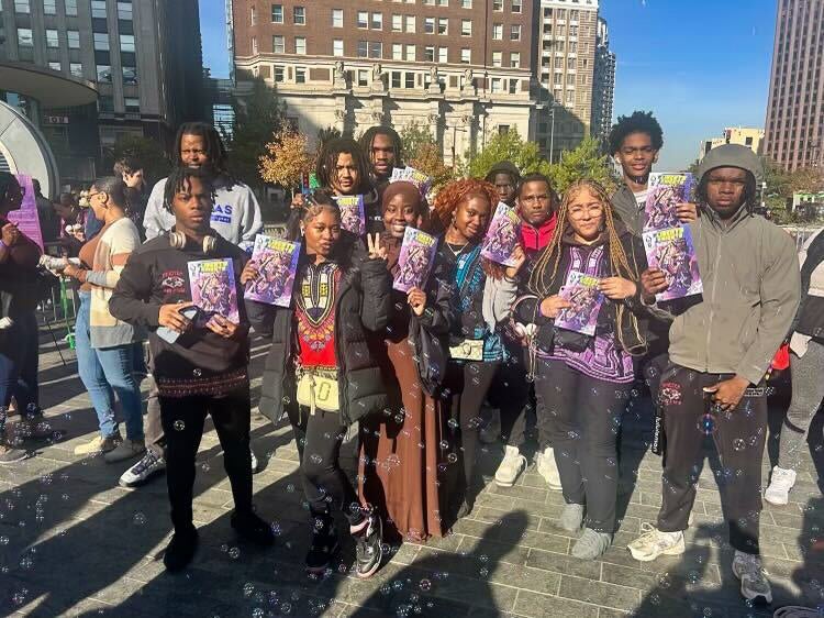 Group photo posing with the comic book