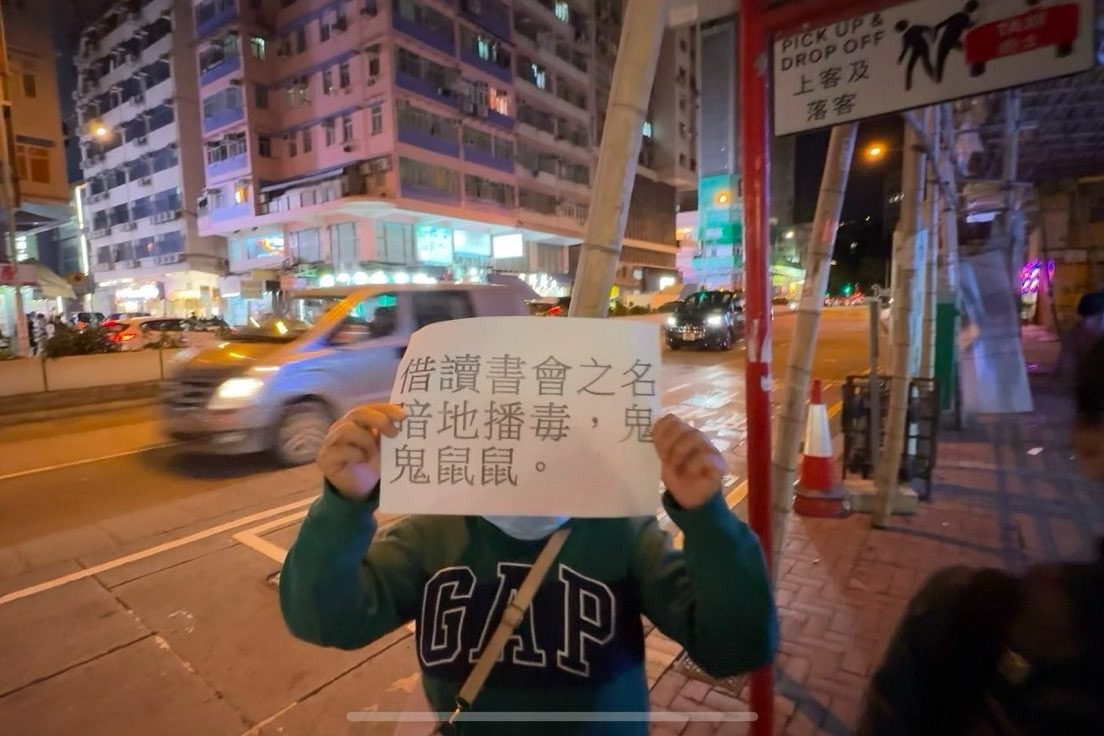 A group of people protest outside of the independent bookshop Talentum on the evening of November 27, 2024 when the travel writer hosts a book launch event. Photo: Pazu.  