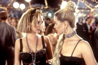 two girls wearing 80s like clothing at a school dance in romy and michele