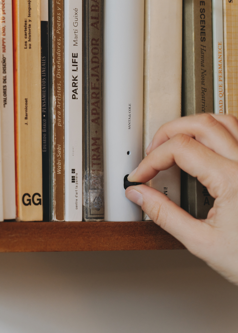 shaped like a book, oscar tusquets' bib luz lamp discreetly integrates into any shelf