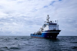 A large ship is seen sailing across the ocean. 