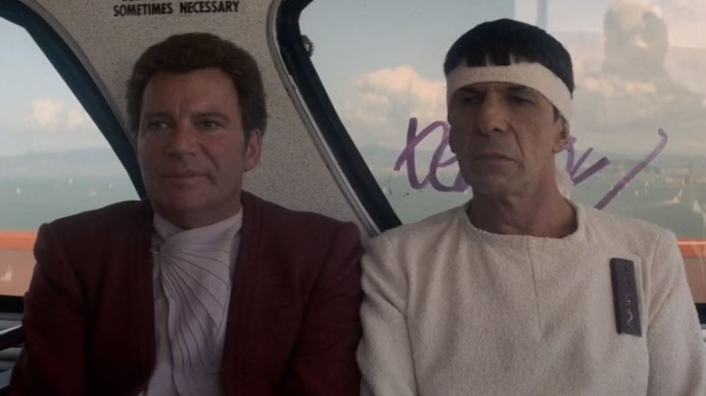 William Shatner and Leonard Nimoy as Kirk and Spock are sitting side by side in Star Trek IV: The Voyage Home