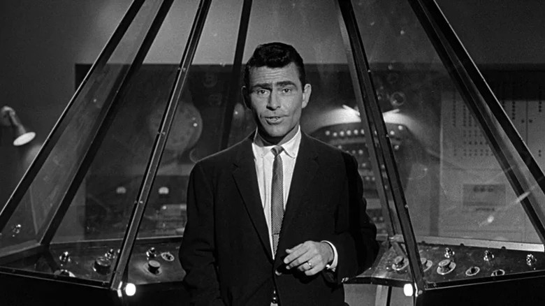 Rod Serling standing in front of a control console in The Twilight Zone (1959)