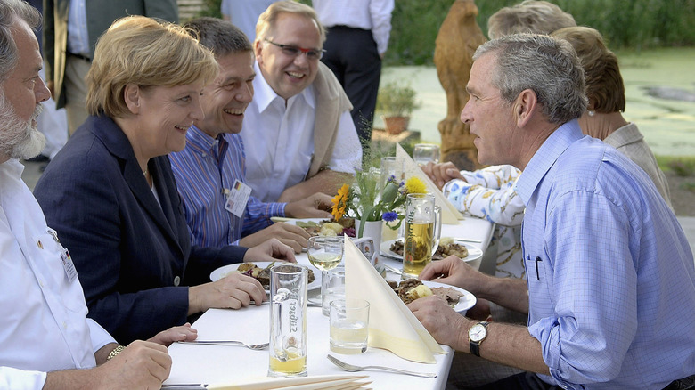 George Bush eating with Angela Merkel