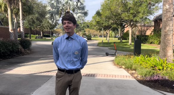 Jacob Hewitt, a student at the University of Central Florida studying biomedical sciences, votes for the first time at Orange Precinct 538 at UCF's Live Oak Center. Hewitt dressed up in a blue shirt and khaki pants for his big day. (Cassidy Mills/Special to the Orlando Sentinel)