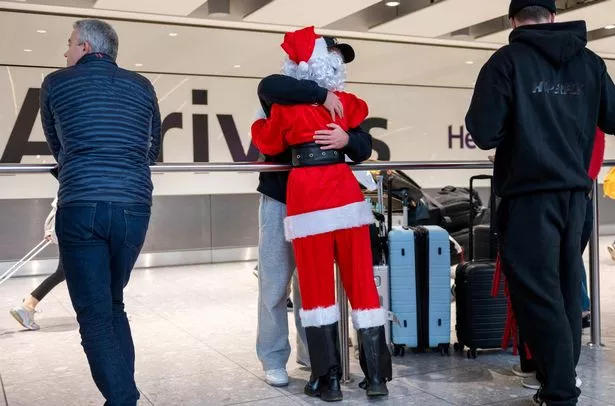 Travellers at Heathrow airport ahead of Christmas, London