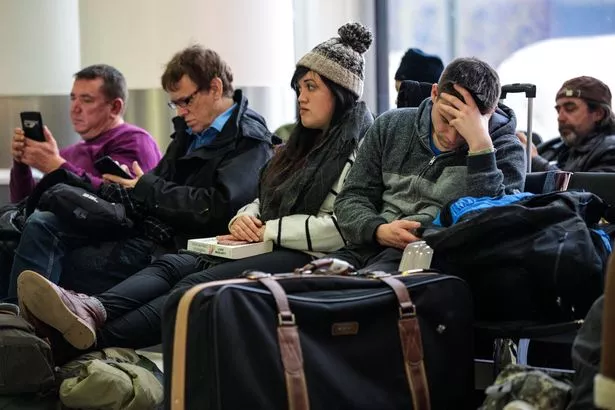 Passengers wait in the South Terminal building at London Gatwick Airport