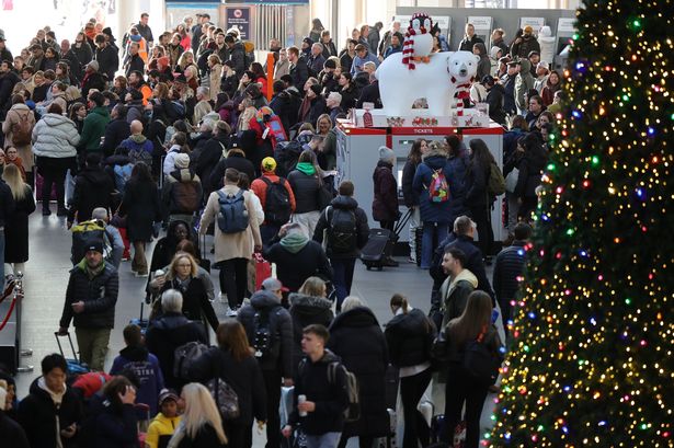 Travellers with luggage at King’s Cross Station in Central London as the Christmas getaway begins