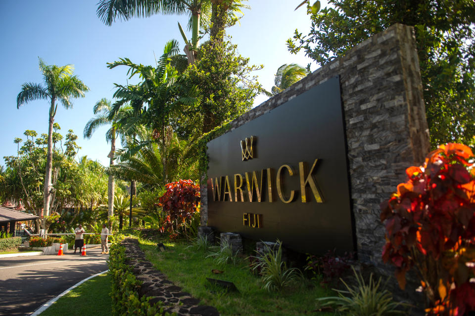 A large sign at the entrance to the Warwick resort.