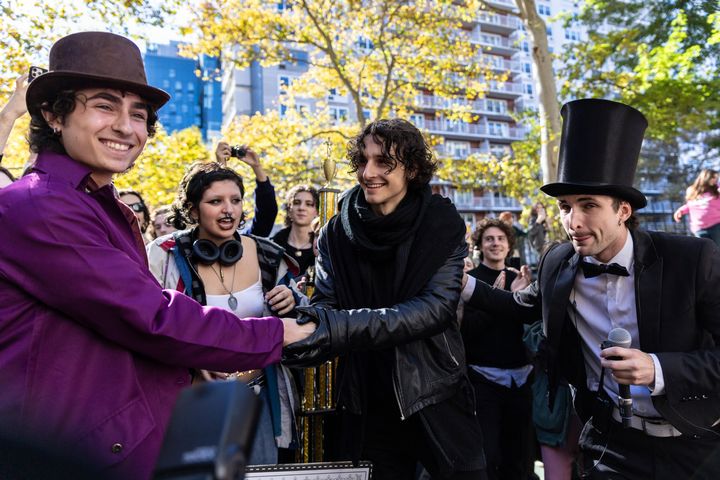 Finalists Miles Mitchell (left) and Zander Dueve (center) shake hands at the Timothée Chalamet look-alike contest in October near Washington Square Park in New York City.