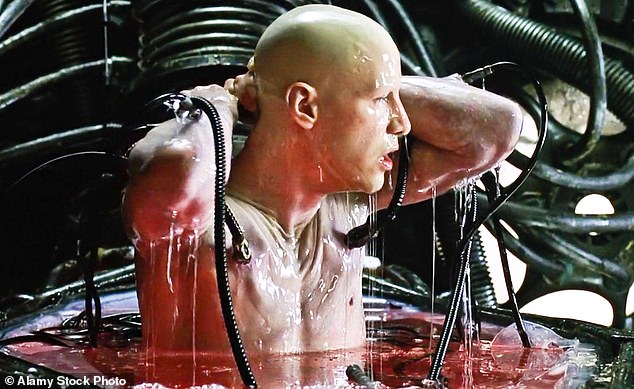 In classic blockbuster film The Matrix, humans are enslaved by AI because they want our body heat to power their computers. Pictured, Keanu Reeves as Neo waking up in the real world