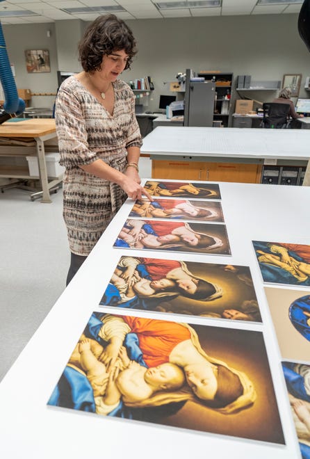 Clowes Conservator of Paintings Roxy Sperber shows images of the various stages of conservation on this Madonna and Child oil painting, from the 1600s, from the Workshop of Sassoferrato (Giovanni Batissta Salvi), Tuesday, Dec. 10, 2024 at the Indianapolis Museum of Art at Newfields. This painting was conserved and has been chosen as one of the images included in this year’s winter holidays’ collection of postage stamps at the United Postal Service.