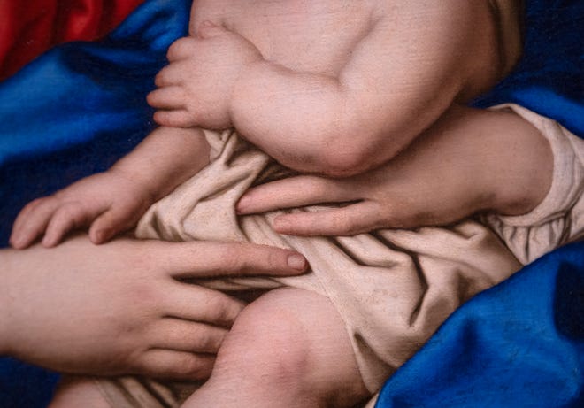 This is a detail of the Madonna and Child oil painting, from the 1600s, from the Workshop of Sassoferrato (Giovanni Batissta Salvi), seen on display Tuesday, Dec. 10, 2024 at the Indianapolis Museum of Art at Newfields. This painting was conserved and has been chosen as one of the images included in this year’s winter holidays’ collection of postage stamps at the United Postal Service.