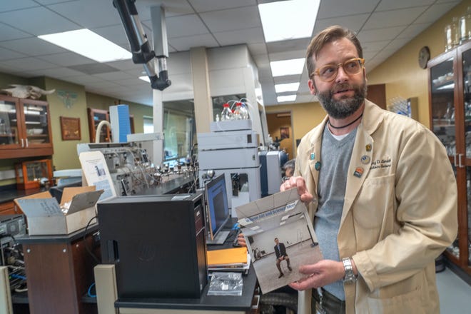 Senior Conservation Scientist Greg Smith shows his analytical lab and shows a 2010 photo of what it looked like when he first started working at the Indianapolis Museum of Art at Newfields. Photo taken Tuesday, Dec. 10, 2024.