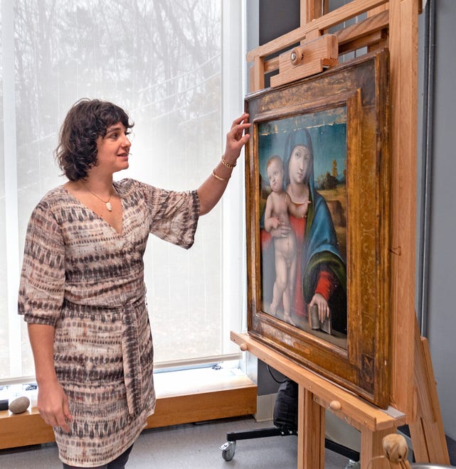 Clowes Conservator of Paintings Roxy Sperber shows a painting she is currently working on Tuesday, Dec. 10, 2024 at the Indianapolis Museum of Art at Newfields. She also conserved a Madonna and Child painting which has been chosen as one of the images included in this year’s winter holidays’ collection of postage stamps at the United Postal Service.