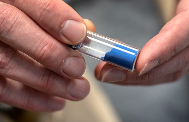 Senior Conservation Scientist Greg Smith shows pigment ground from aquamarine rock that is mined in Afghanistan. Natural aquamarine rock was used centuries ago for making pigment for artists to use in painting. The original was so valuable and followed an amazing trade route to get to artists. Since the 1820s, there is now a chemically identical synthetic version than can be made in labs. Photo taken Tuesday, Dec. 10, 2024 at the Indianapolis Museum of Art at Newfields.