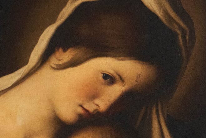 This is a detail of the Madonna and Child oil painting, from the 1600s, from the Workshop of Sassoferrato (Giovanni Batissta Salvi), as it was found before conservation at the Indianapolis Museum of Art at Newfields. A tear in the painting on the Madonna’s forehead shows an earlier repair that discolored at a different rate from the original. This painting was conserved and has been chosen as one of the images included in this year’s winter holidays’ collection of postage stamps at the United Postal Service. Photo taken Tuesday, Dec. 10, 2024.