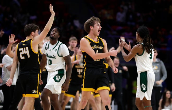 Michigan Tech's Marcus Tomashek (1) celebrates after winning a game against University of Wisconsin-Green Bay on Dec. 18, 2024, at the Resch Center in Ashwaubenon, Wis.