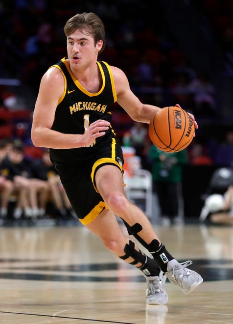 Michigan Tech's Marcus Tomashek (1) takes the ball down the court during a game against University of Wisconsin-Green Bay on Dec. 18, 2024, at the Resch Center in Ashwaubenon, Wis.