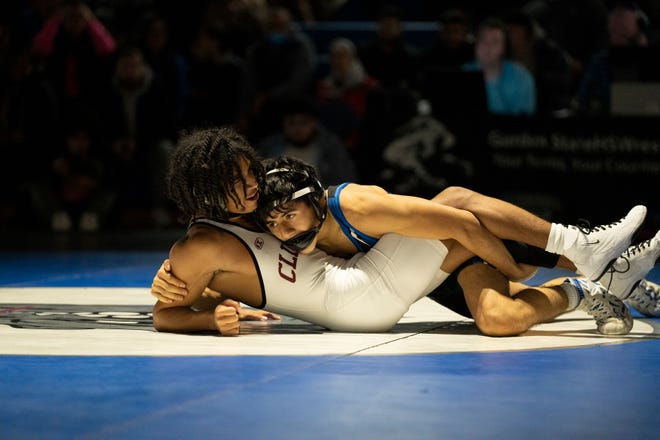 Dec 20, 2024; Wayne, NJ, USA; Clifton wrestling at Passaic Tech. (Right) Passaic Tech’s Marco Barro and Clifton’s Christopher Olivo in their 113 pound match.