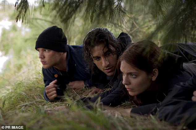 Lewis is well-known for his role as Kevin Holmes in the 2010 film adaptation of Marsden's adventure book, Tomorrow, When The War Began (left with Deniz Akdeniz and Caitlin Stasey)