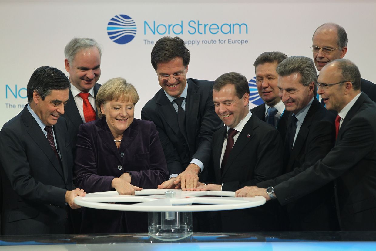 Leaders turn a wheel to start gas flow through the Nord Stream pipeline in Lubmin, Germany, on Nov. 8, 2011.