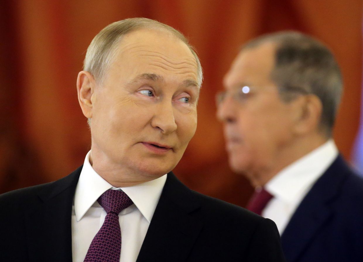 Russian President Vladimir Putin smiles as Foreign Minister Sergey Lavrov looks on at a reception in Moscow, Russia, on Nov. 5, 2024.