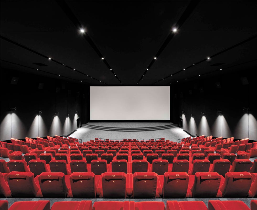 theatre rendering with starry black backdrop and screen and red theater seating