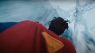 A close up of Superman flying over an icy location in James Gunn's Superman movie