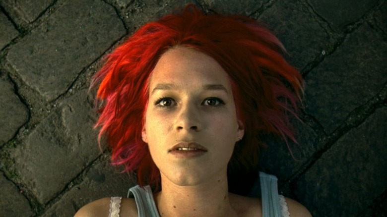 Lola lying on the sidewalk, her fiery red hair splayed out around her in Run Lola Run