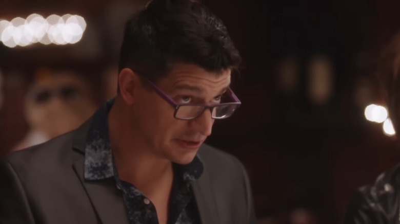 Ken Marino as Streeter Peter looking over his glasses at a fancy restaurant on The Other Two