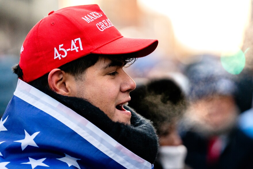 Juan Charryy, 27, of Zurich, Switzerland, speaks to a fellow Donald Trump supporter in cold temperatures while waiting to enter a rally marking the president’s second inauguration on Monday, Jan. 20, 2025, in Washington D.C.