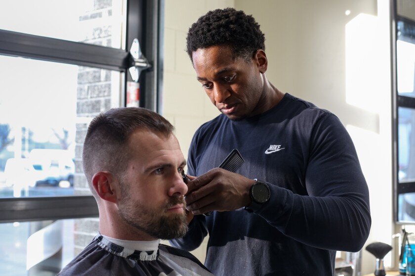 Jared Osburnsen cuts Ezra VanDenEinde's hair at Nice Barber Company on Monday, Jan. 6, 2025, in north Fargo. 